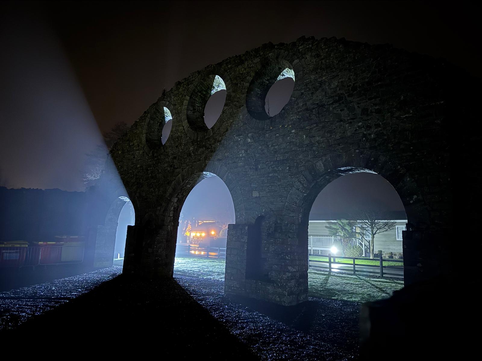 The old Iron Works arches with StepAway visible beyond at night
